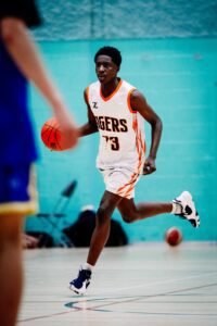 Kent Tigers player dribbling the basketball