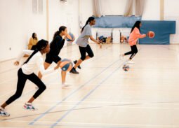 Girls dribbling the basketball